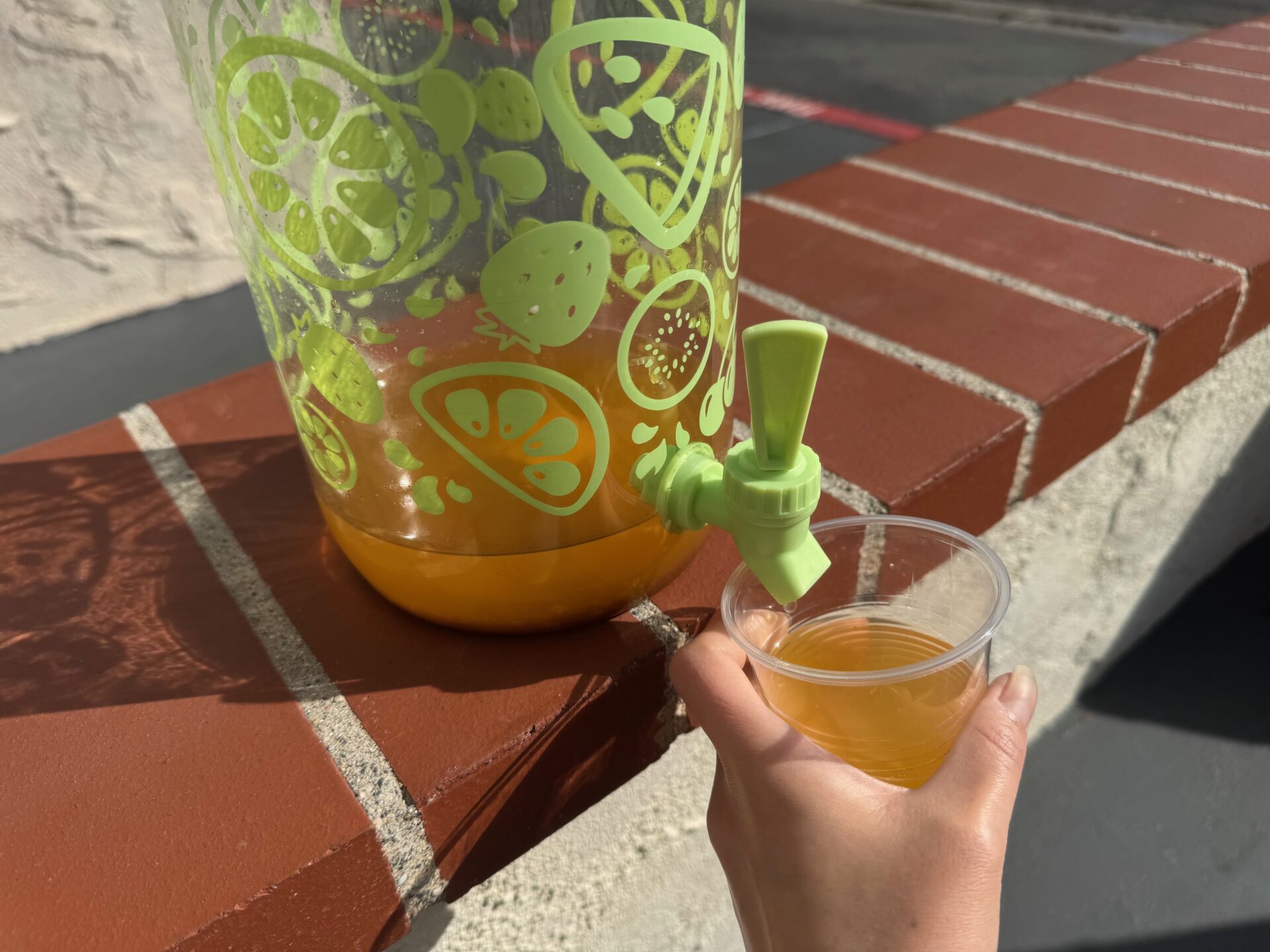 ドリンクサーバーからコップにお酒をそそいだ写真