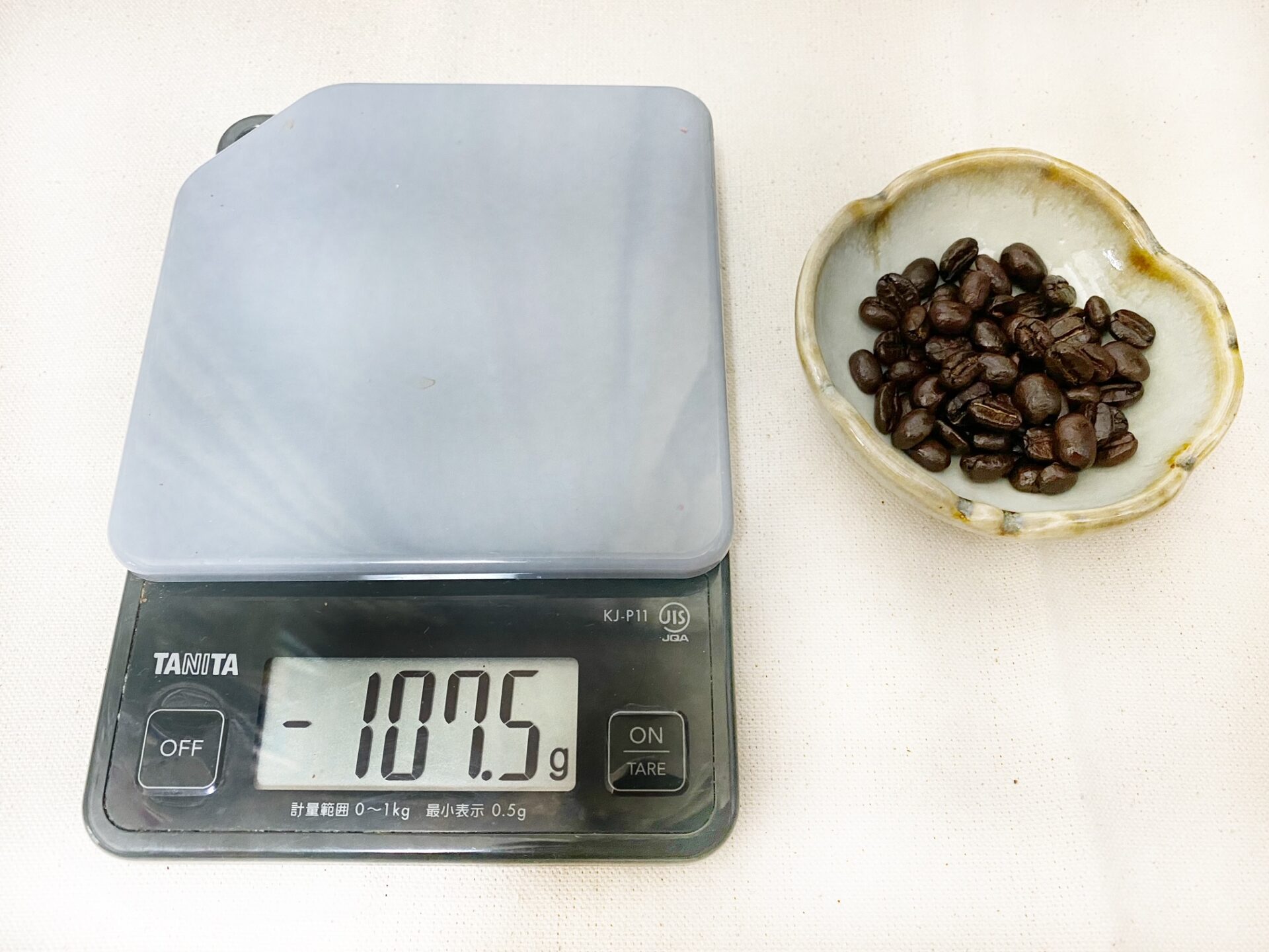 お皿とコーヒー豆を計量皿からおろした写真。マイナス１０７．５グラムと表示されています