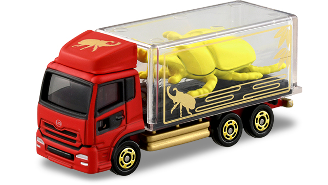 UDトラックス クオンかぶとむしの商品写真。赤がベースのトラックの荷台部分が透明になっており、なかに黄色のカブトムシがいっぴきのっています。すごいインパクトです